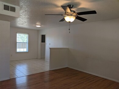 Living area open to dining and kitchen