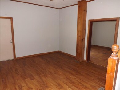 LR with new plank flooring.  Door to the left in E