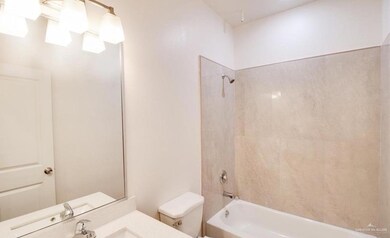 Full bathroom with toilet, vanity, and washtub / shower combination