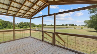 Unfurnished sunroom with a water view and lofted ceiling
