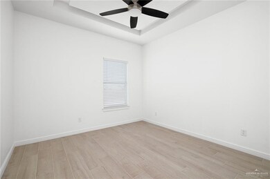 Unfurnished room featuring light wood-type flooring and ceiling fan
