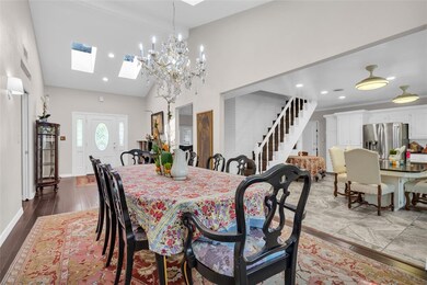 Dining area with stairway, a skylight, high vaulte