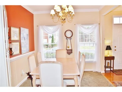 Lovely crown molding and plush carpet in the dining room.