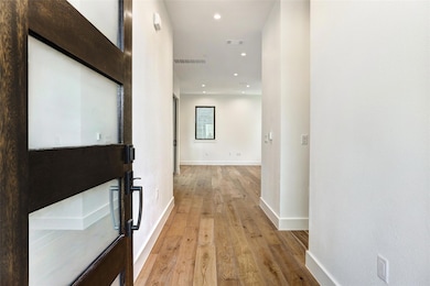 Hall featuring light wood-type flooring, baseboar