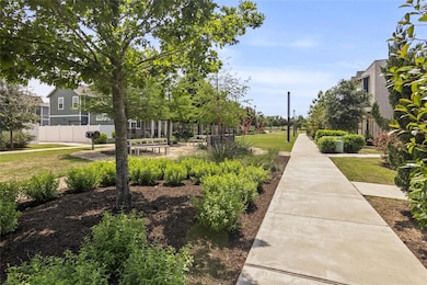 View of community with a lawn and fence