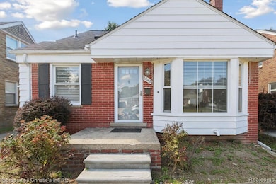 View of front facade featuring a chimney, brick siding, and roof with shingles