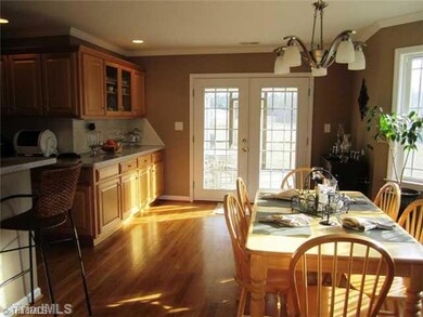 Dining Room. Dining room with extended custom cabinetry and french doors leading to screened porch
