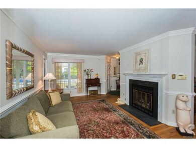 Living room with gas logs, hardwoods, crown mouldi