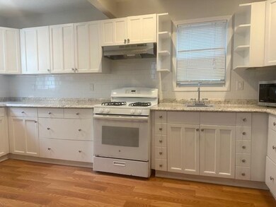 Kitchen featuring open shelves, white gas range, w