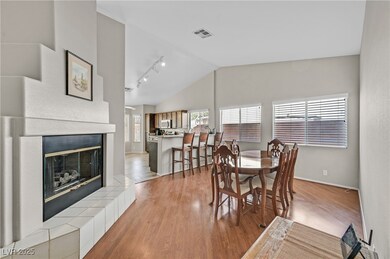 Dining space featuring vaulted ceiling, track ligh