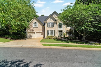 Traditional home with concrete driveway, stucco si