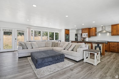 Living area with recessed lighting and light wood finished floors