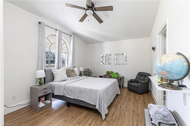 Bedroom featuring vaulted ceiling, ceiling fan, an