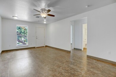 Spare room with a ceiling fan and baseboards