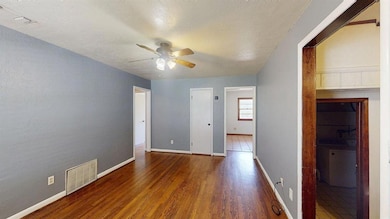 Spare room with hardwood floors, ceiling fan