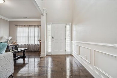 Foyer entrance featuring crown molding, wood-type 