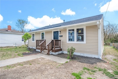 View of front of property featuring fence and roof
