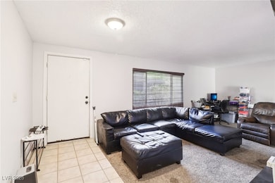 Living area featuring a textured ceiling and light