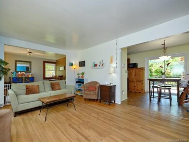 Living area with view into kitchen and into dining room/play room