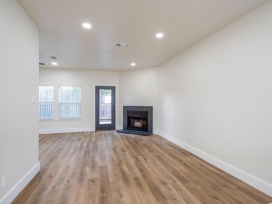 Unfurnished living room featuring wood finished f