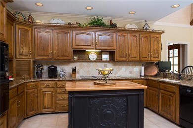 So much space in this kitchen with tons of cabinets, a fantastic sink, new fridge, granite counters and beautiful tile backsplash. 