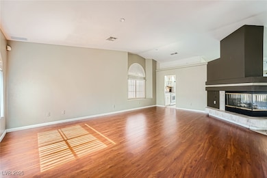 Unfurnished living room featuring vaulted ceiling,