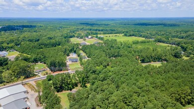 View of property location with a heavily wooded area