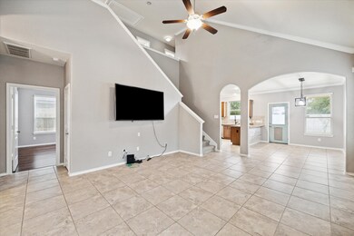 View of the Family Room Highlighting Fresh Paint, Tile Floors, Ceiling Fan, Vaulted Ceiling and Large Screen TV Stays!