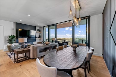 Dining area featuring expansive windows, light wood-style flooring, and recessed lighting