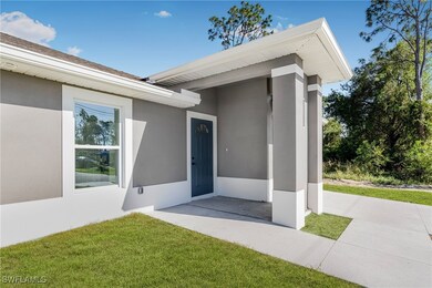 Doorway to property featuring a lawn