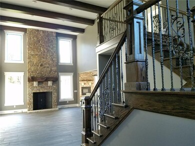 Beautiful 2 Story Family Room has stained wood bea