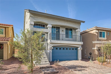 View of front of home with a garage, driveway, sta