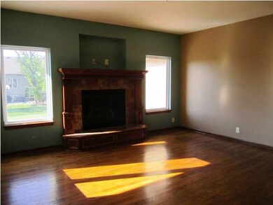 Upstairs family room offers wood floors and a wond