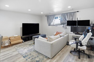 Living room with an office area, recessed lighting, and light wood-style floors