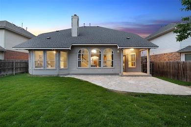 Rear view of property featuring a chimney, roof w