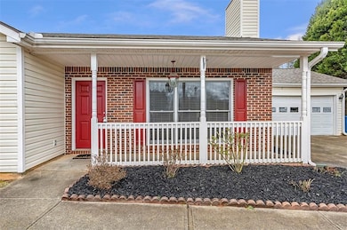 Doorway to property featuring driveway, a chimney,