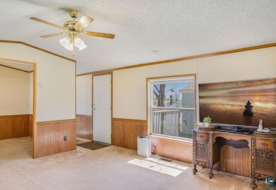 Home office with a wainscoted wall, ceiling fan, a