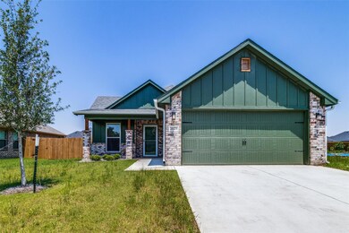 Craftsman house with a garage and a front yard