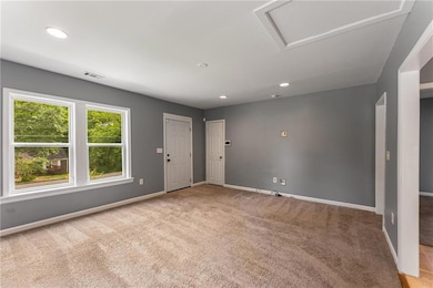 Foyer with carpet flooring, baseboards, and recessed lighting