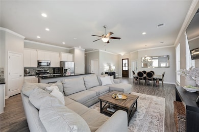 Living room featuring a chandelier, dark wood fini