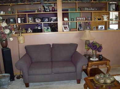 Wall divider with bookcase and cabinets below.