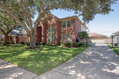 An electric wrought iron gate on the double wide driveway adds extra protection.