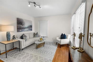 Living area featuring light wood-type flooring and baseboards