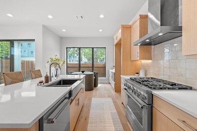 Kitchen featuring light brown cabinets, appliance