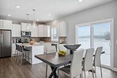 Soaked in natural sunlight, the homes eat-in dining area has ample space for a dining table located in the heart of the home. (Photo of decorated model, actual home's finishes may vary slightly)