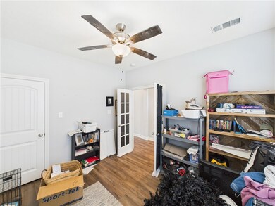 Office with ceiling fan, wood finished floors, and