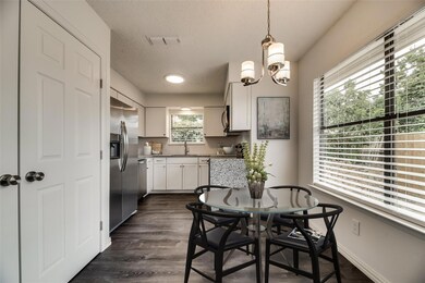 Dining space with dark hardwood / wood-style floor