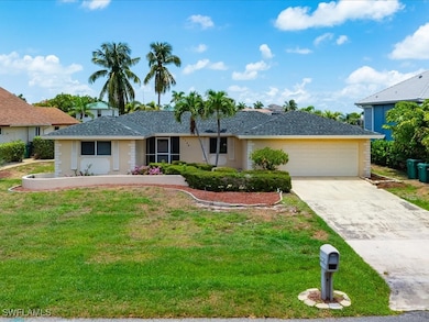 Ranch-style house with a front lawn and a garage