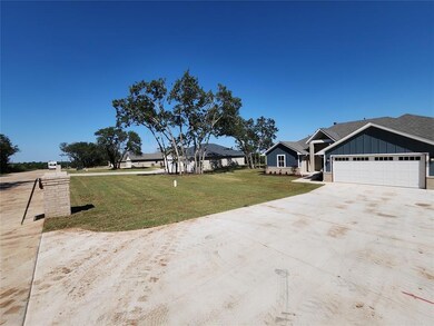 View of front facade with driveway, an attached ga