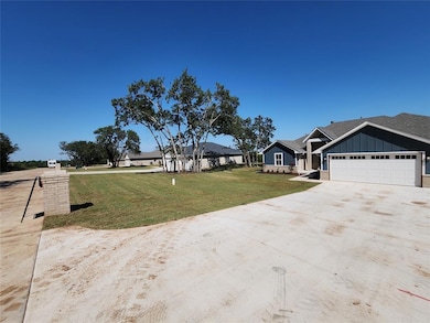 View of front facade with driveway, an attached ga